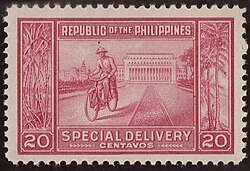Man cycling past a building